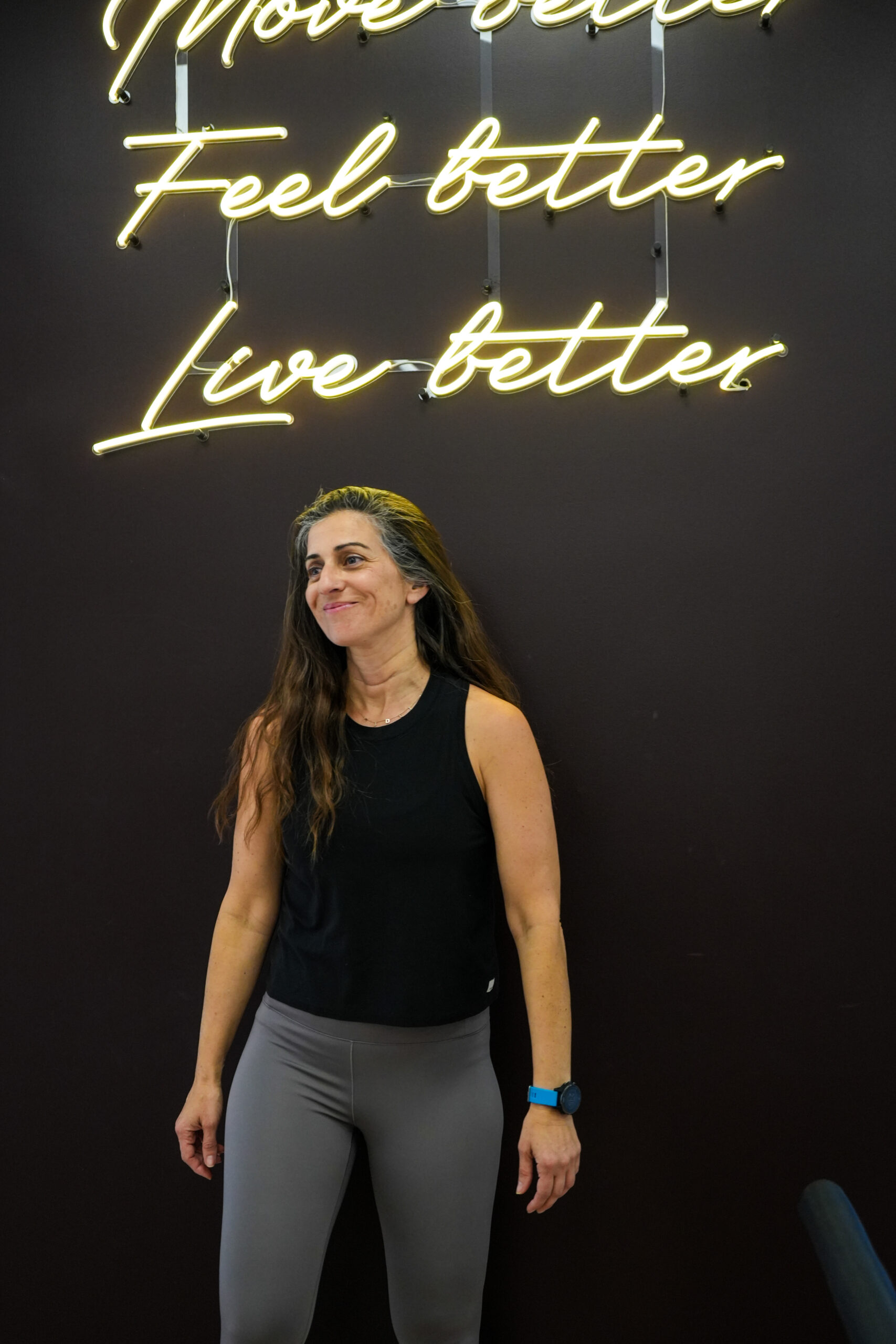 Move Better Feel Better Live Better neon sign at YA FIT Pilates