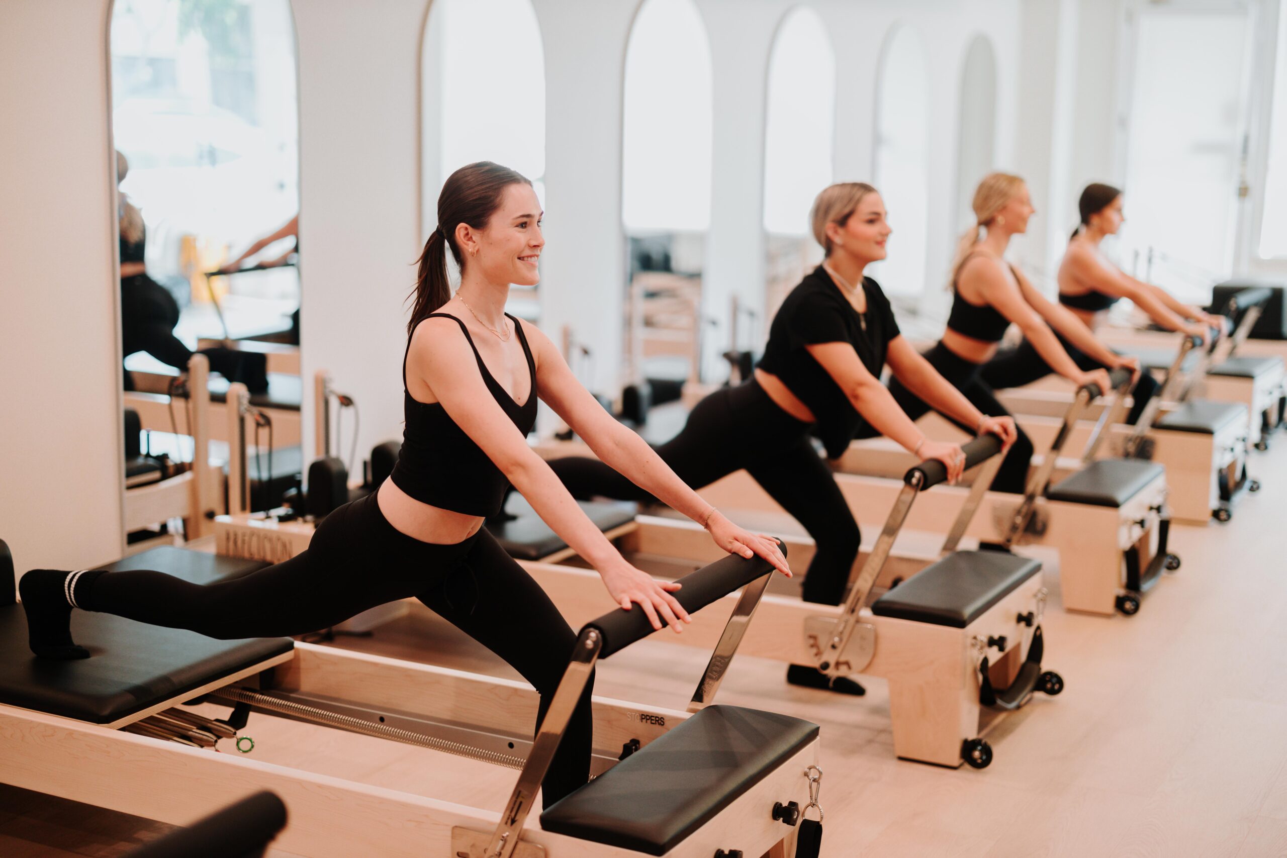 Members working through a reformer sequence at YA FIT Pilates