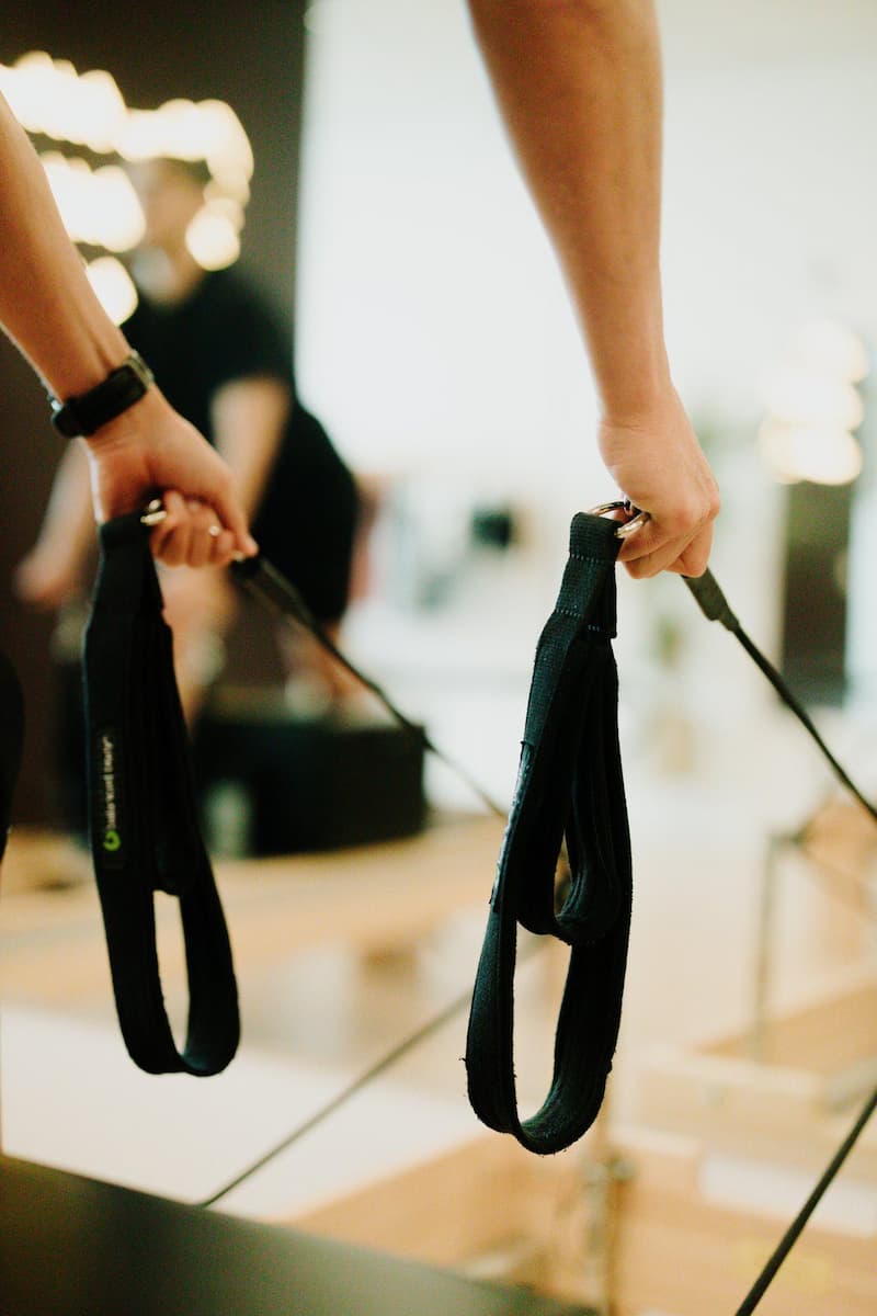 Reformer straps pulling at YA FIT Pilates studio