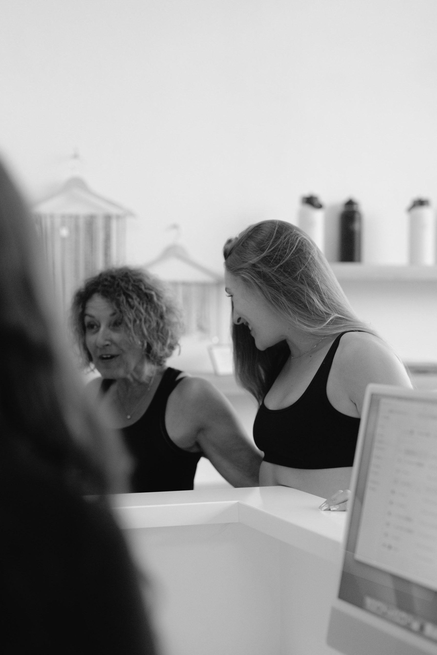 A member being welcomed at the front desk at YA FIT Pilates Agoura Hills